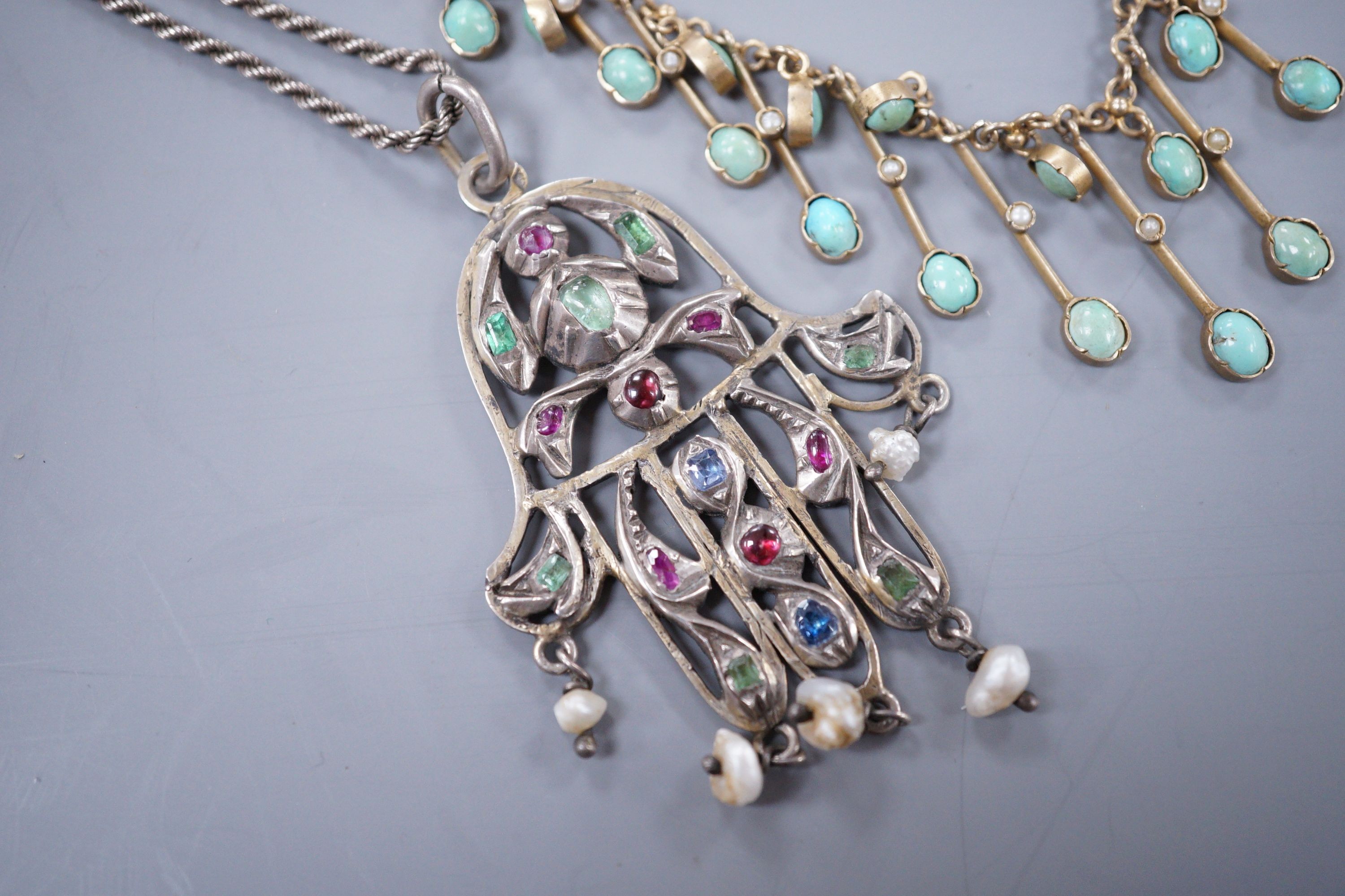 A Continental gem set white metal Hand of Fatima pendant, and a base metal turquoise set fringe necklace